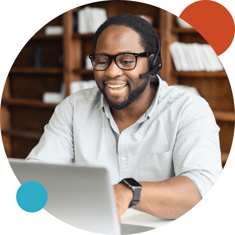 African American man wearing headset and using computer